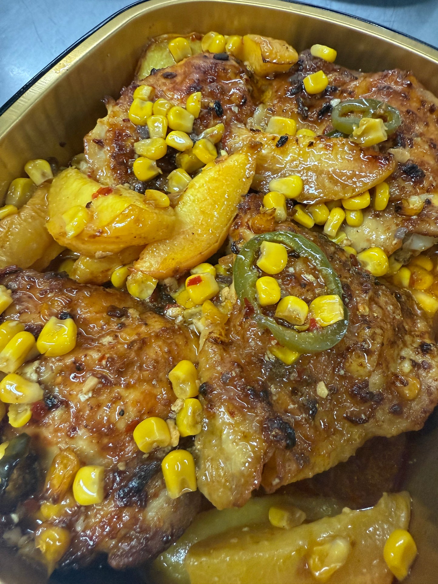 Roasted chicken thighs w/ peaches, corn & jalapeños