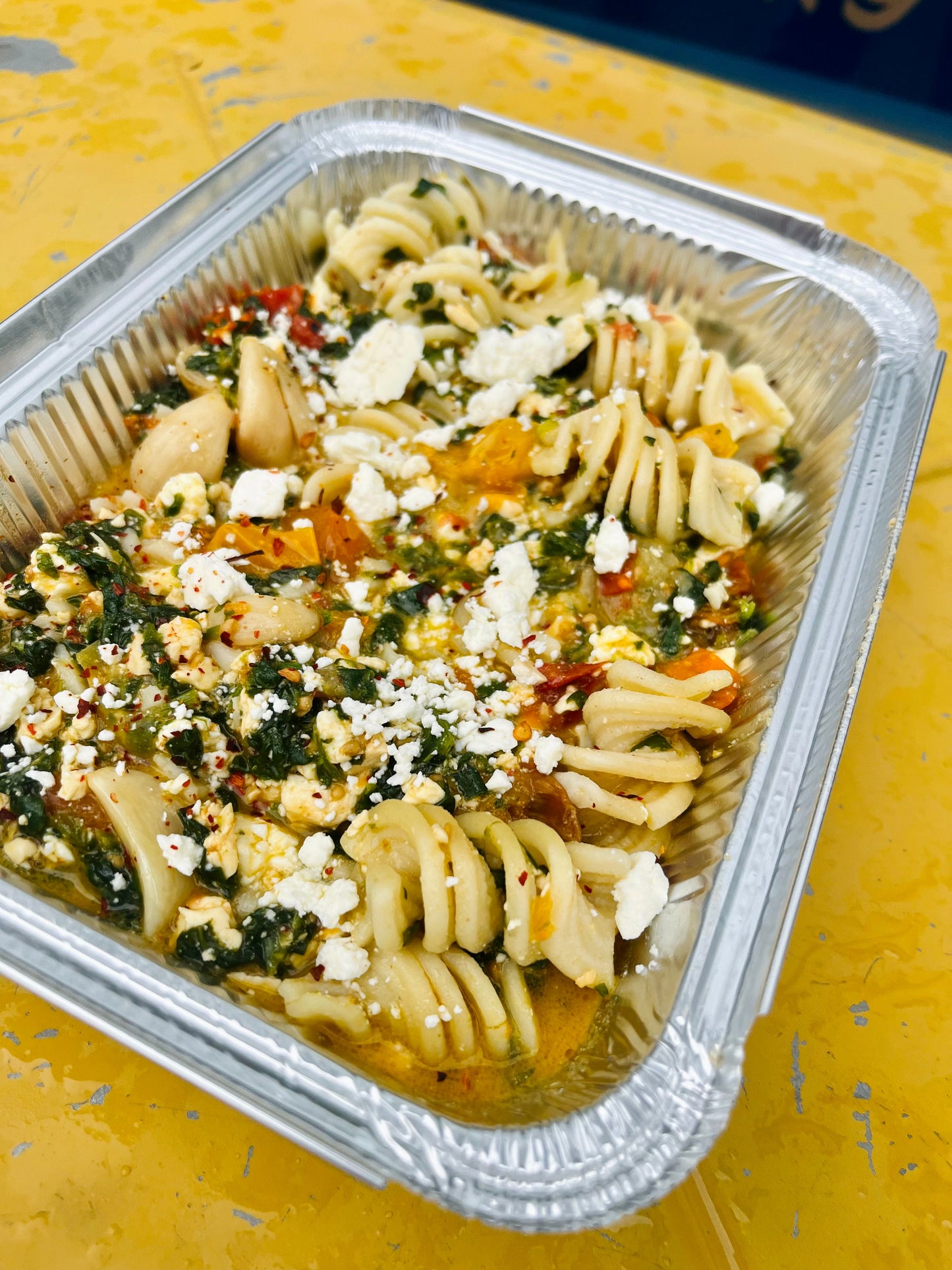 Smoked feta and tomato pasta bake with spinach and lemon