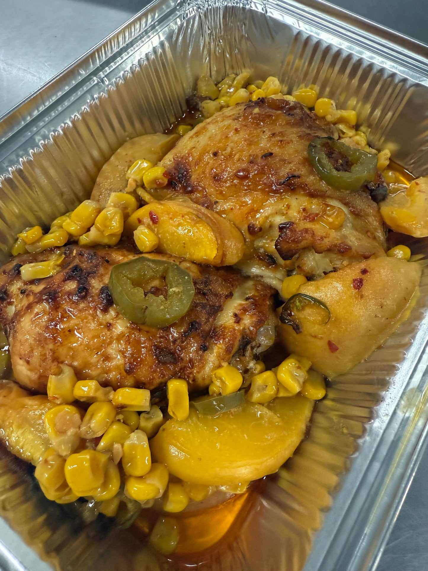 Roasted chicken thighs w/ peaches, corn & jalapeños